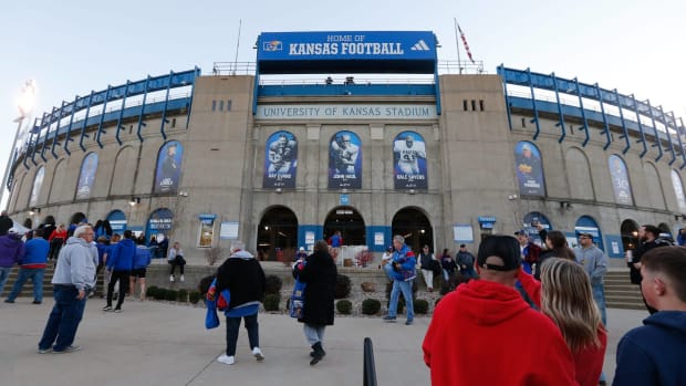 Fans walk into David Booth Kansas Memorial Stadium before a game.